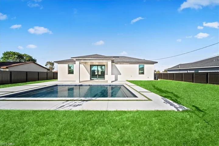 Rear view of property featuring a fenced backyard, stucco siding, and a patio
