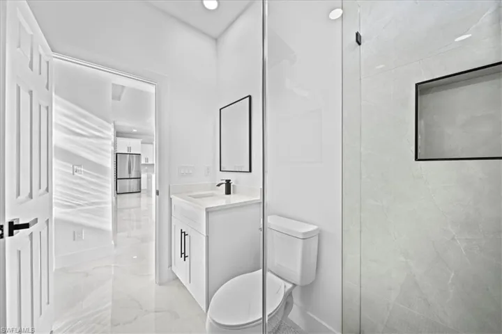 Bathroom featuring vanity and light marble finish floors