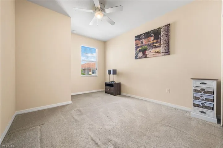 Carpeted bedroom with ceiling fan