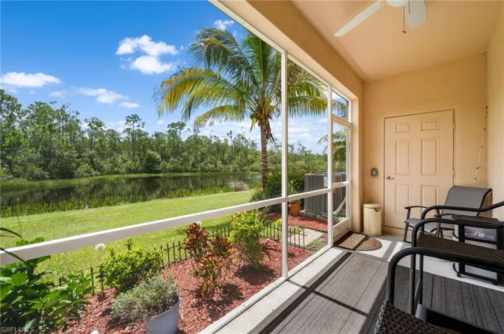 Balcony with central air condition unit, a water view, and ceiling fan