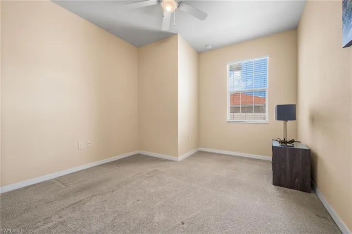 Spare room with light colored carpet and ceiling fan