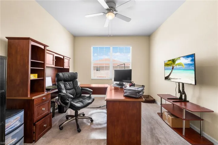 Carpeted office with ceiling fan