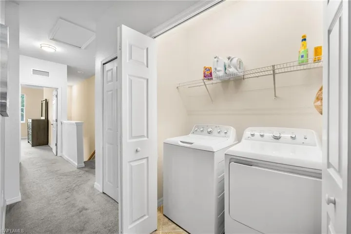 Upstairs laundry room with separate washer and dryer