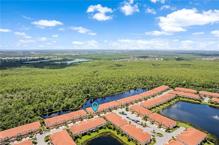 Birds eye view of property with a water view