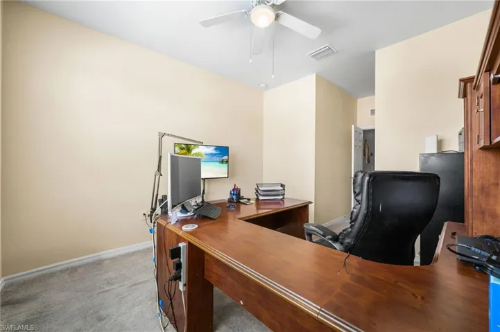Office featuring light carpet and ceiling fan