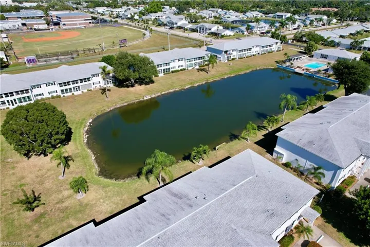 Aerial view of residential area featuring a nearby body of water