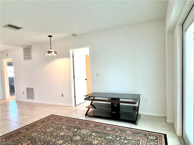 dining area featuring light tile patterned floors and baseboards