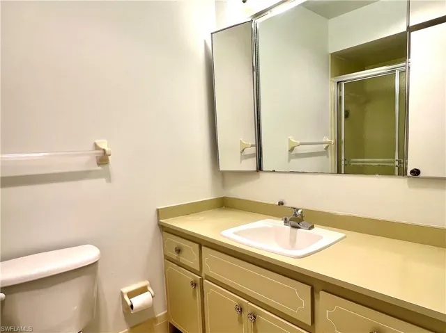 Bathroom featuring a stall shower and vanity