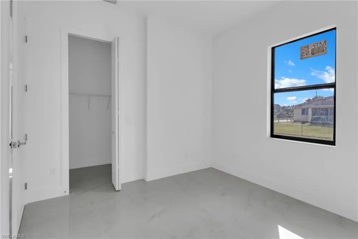 Unfurnished bedroom featuring a closet and a spacious closet