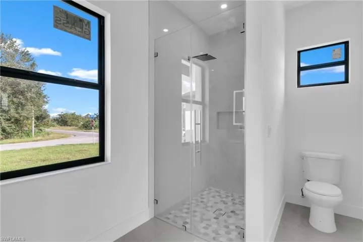 Bathroom with toilet and a shower with shower door