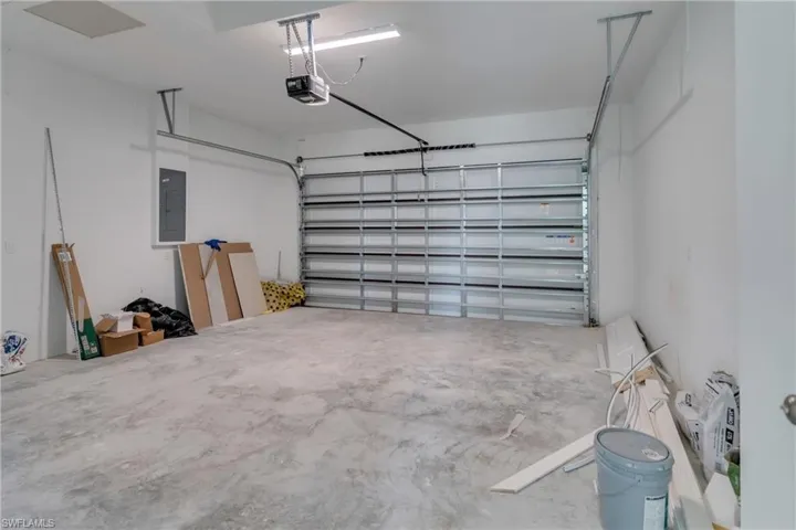 Garage with electric panel and a garage door opener