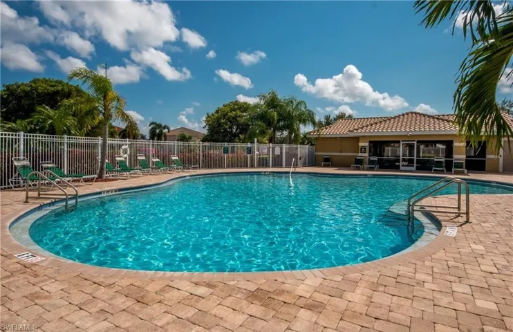 Community pool with a patio
