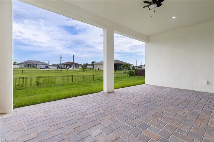 Fenced backyard featuring a patio area and a ceiling fan