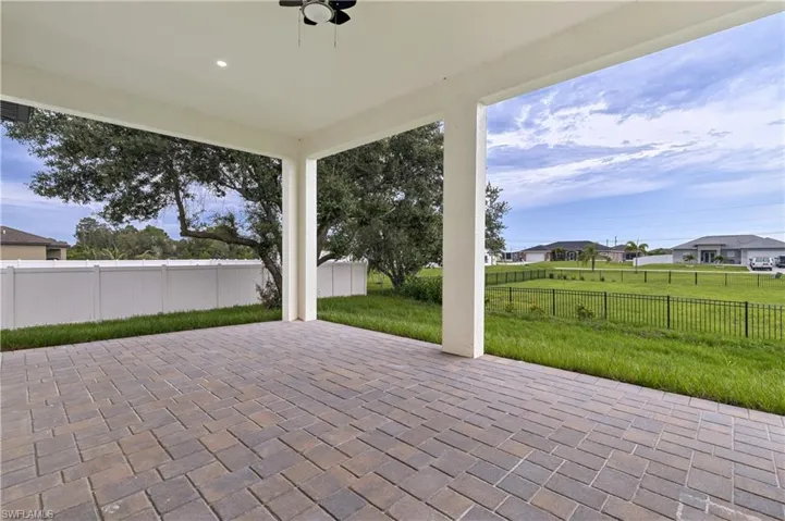 Fenced backyard with a patio area and a residential view