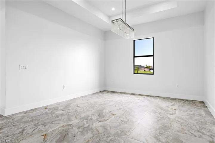 Empty room featuring recessed lighting and marble finish flooring