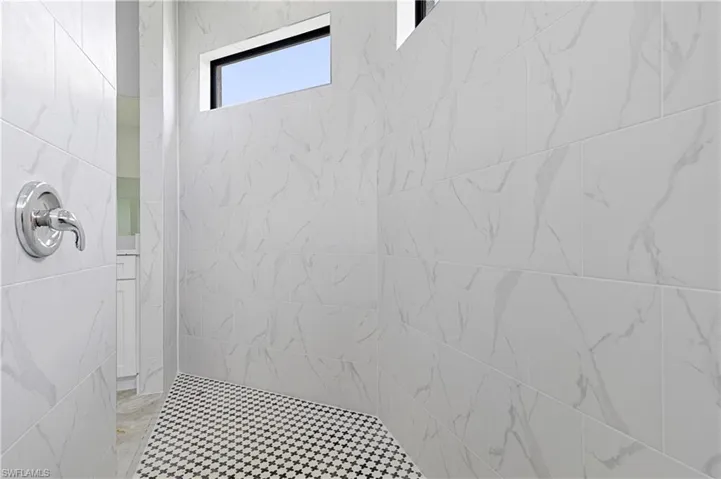 Full bathroom featuring tiled shower