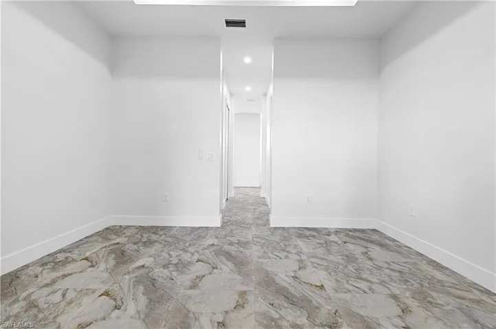 Unfurnished room with baseboards