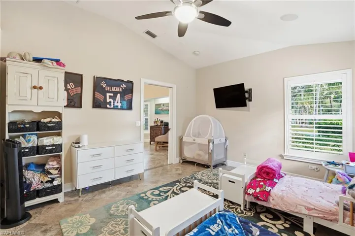 Bedroom with lofted ceiling and a ceiling fan