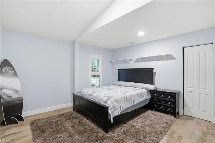 Bedroom with light wood-type flooring and a closet