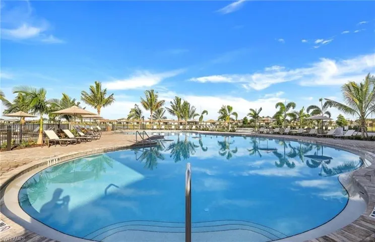 Community pool with a patio