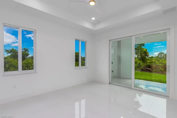 Tiled spare room with ceiling fan