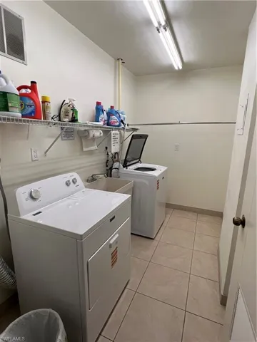 Dedicated shared free laundry room featuring tile flooring. Each floor has their own room. Just bring your laundry detergent and supplies
