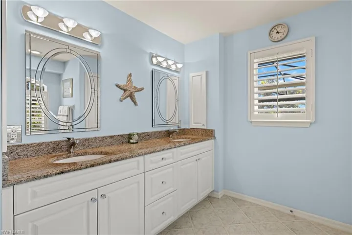 Bathroom with tile patterned flooring and vanity