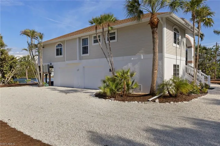 View of side of property with a garage