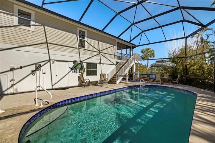 View of swimming pool with a lanai and a patio area