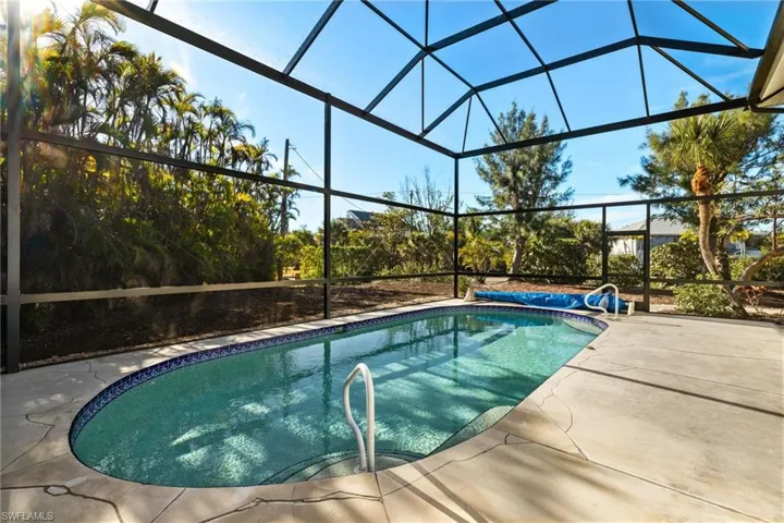 View of swimming pool with a lanai and a patio