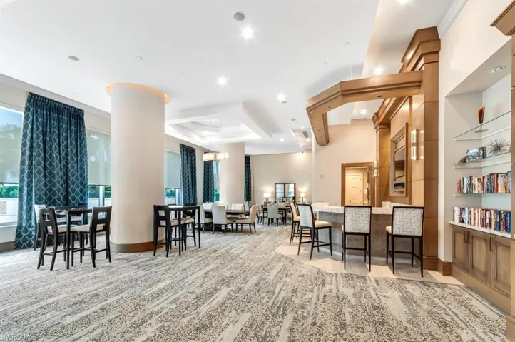 Dining space featuring a tray ceiling, light colored carpet, and recessed lighting