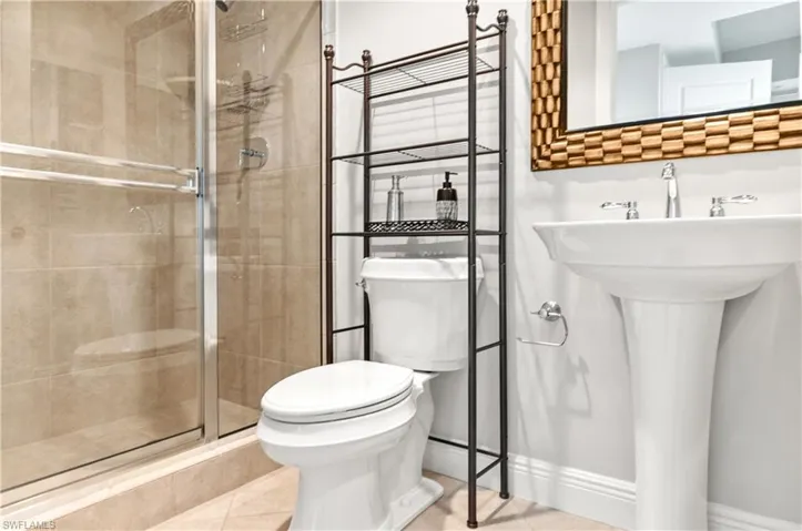 Bathroom featuring a stall shower and tile patterned flooring