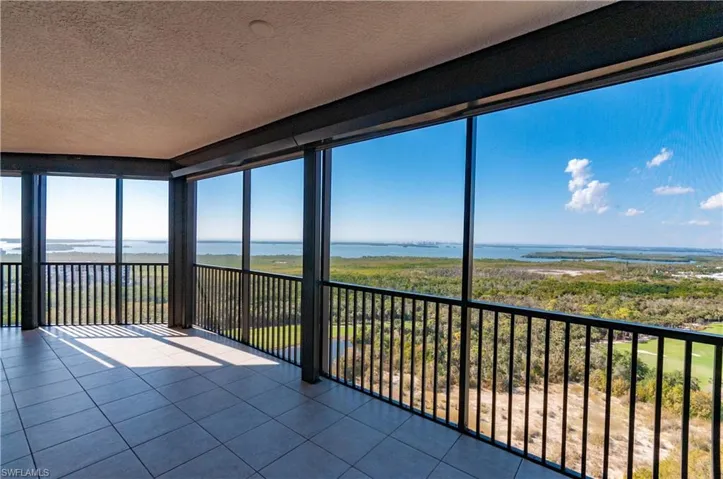 Unfurnished sunroom featuring a water view