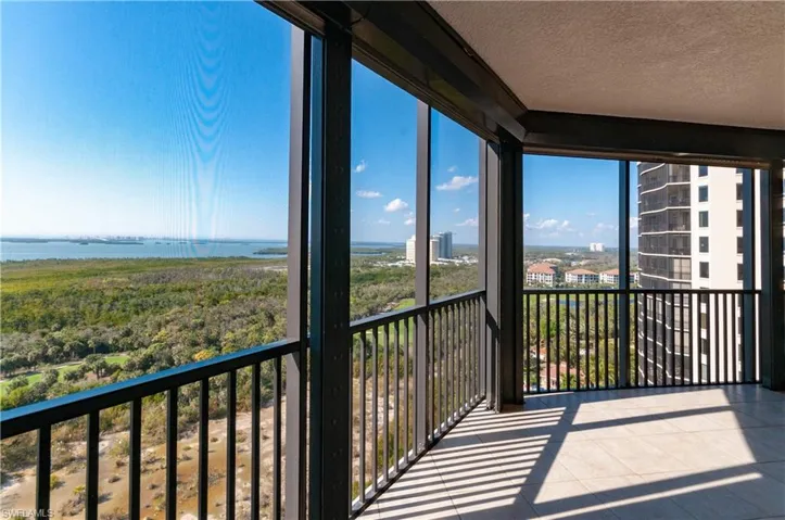 Balcony with a sunroom and a water view