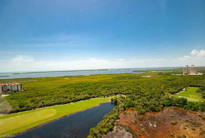 Drone / aerial view of a large body of water and a golf course