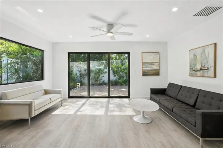 Living room featuring ceiling fan, light wood-type flooring, and recessed lighting