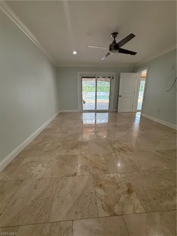 Spacious Master bedroom featuring polished stone tile flooring, crown molding, and recessed lighting