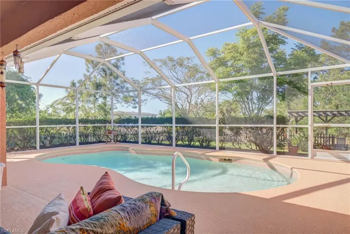 Outdoor pool with glass enclosure and a patio