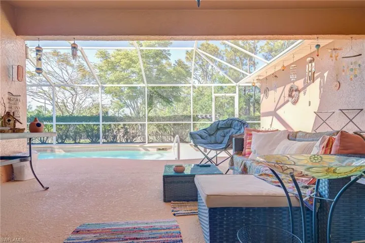 Pool featuring glass enclosure and a patio area