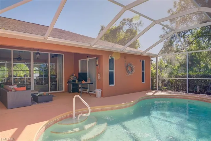 Outdoor pool featuring a patio and glass enclosure