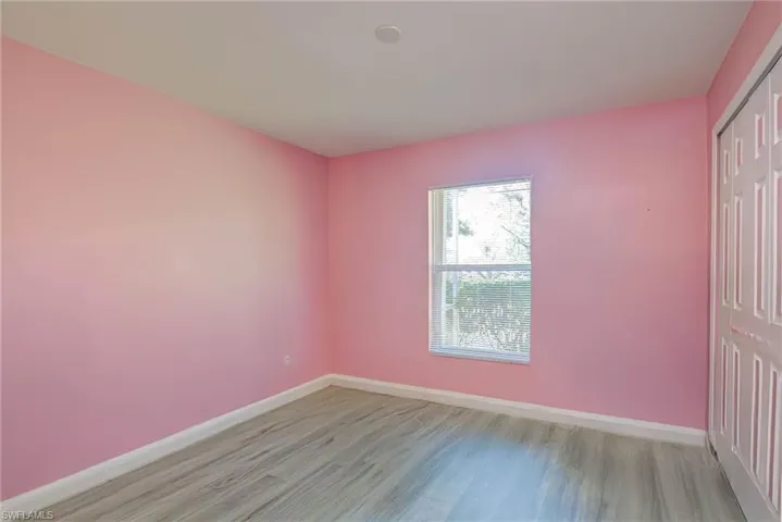 Empty room featuring baseboards and light wood-style floors