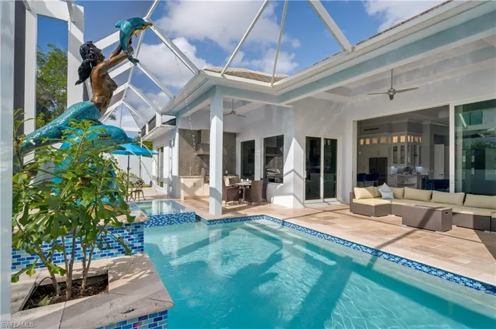 View of pool with outdoor lounge area, a sunroom, a patio area, and a lanai