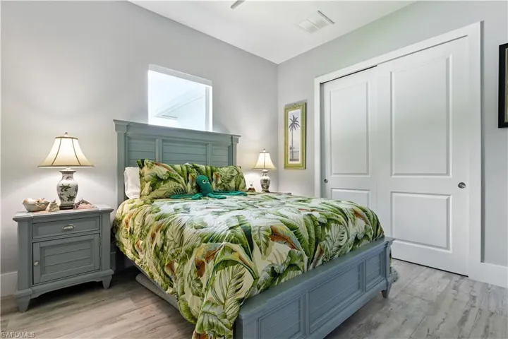 Bedroom featuring light wood-style floors and a closet