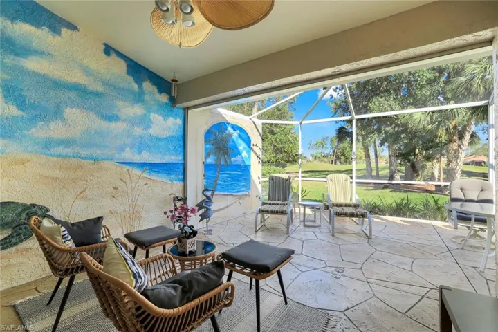 View of patio featuring glass enclosure and a ceiling fan