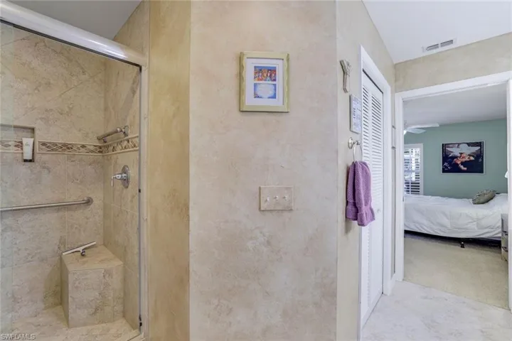 Ensuite bathroom with ensuite bathroom, a shower stall, and visible vents