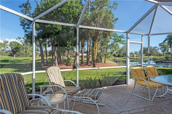 Sunroom featuring a water view
