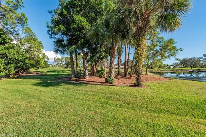 View of grassy yard with a water view