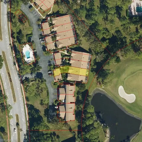 Aerial perspective of suburban area featuring a large body of water and a golf club