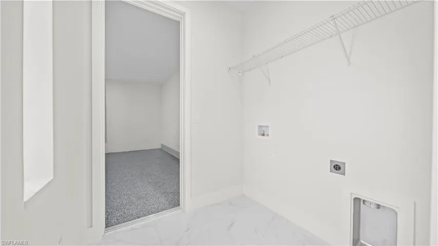 Washroom with light marble finish flooring, washer hookup, and electric dryer hookup