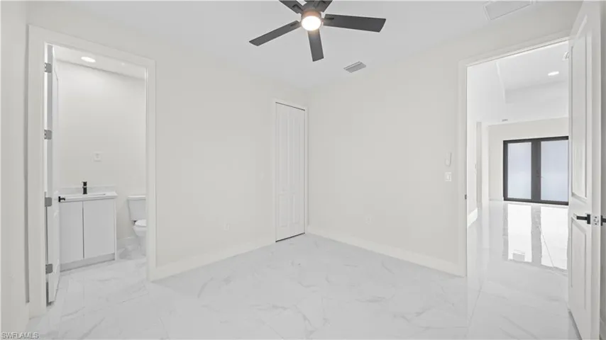 Spare room featuring light marble finish floors, recessed lighting, and a ceiling fan